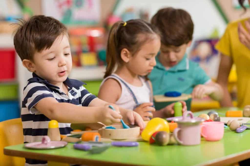 preschool students playing pretend with cooking items